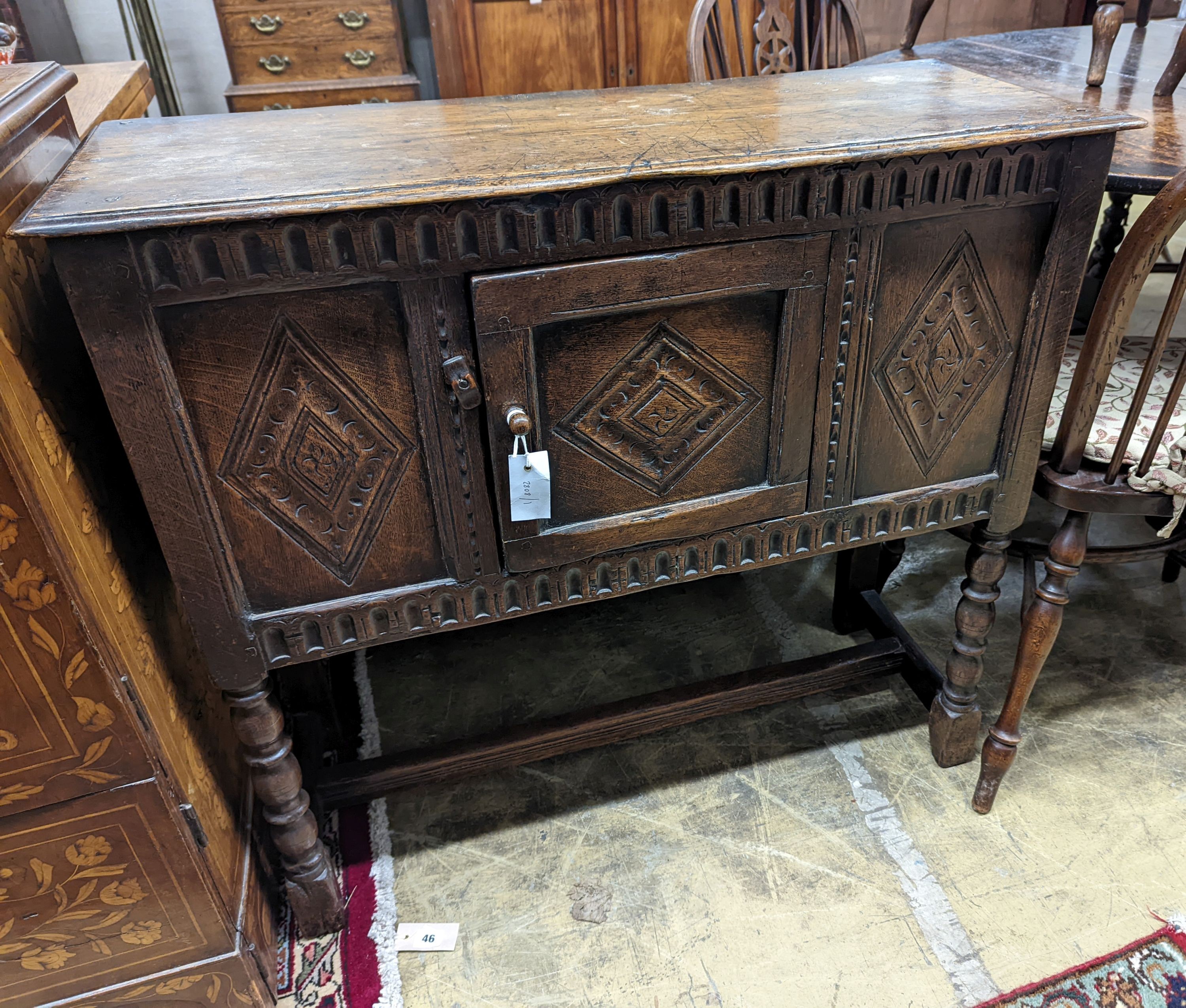 An 18th century style carved oak side cabinet, width 90cm, depth 35cm, height 83cm